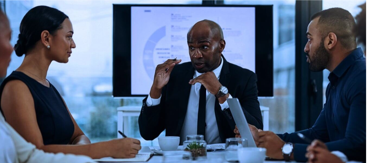 Business professionals discussing ideas around a meeting table